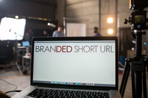 A modern computer screen displaying a branded short URL link, set in a stylish digital marketing workspace with atmospheric lighting.