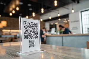 A close-up of a dynamic QR code in a minimalistic design, surrounded by a blurred background of a stylish café or urban workspace, highlighted by soft lighting to indicate modern technology.